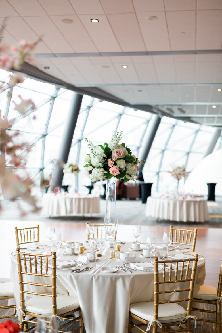A reception table with a floral centrepiece.