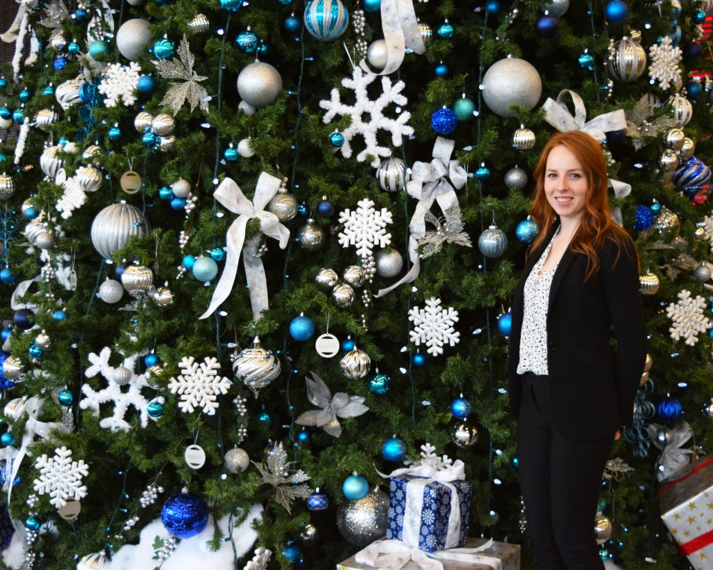 Kelsey Coles in front of Christmas Tree