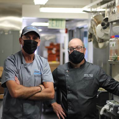 two chefs standing in a kitchen