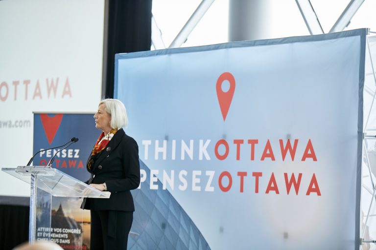 Nina Kressler speaking at a podium