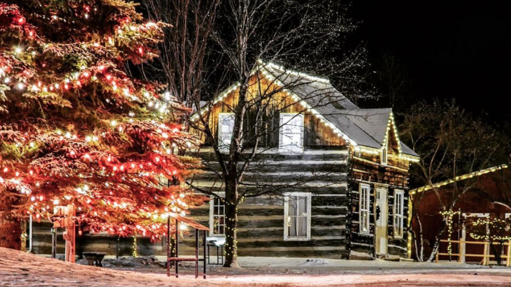 log house at night with christmas lights