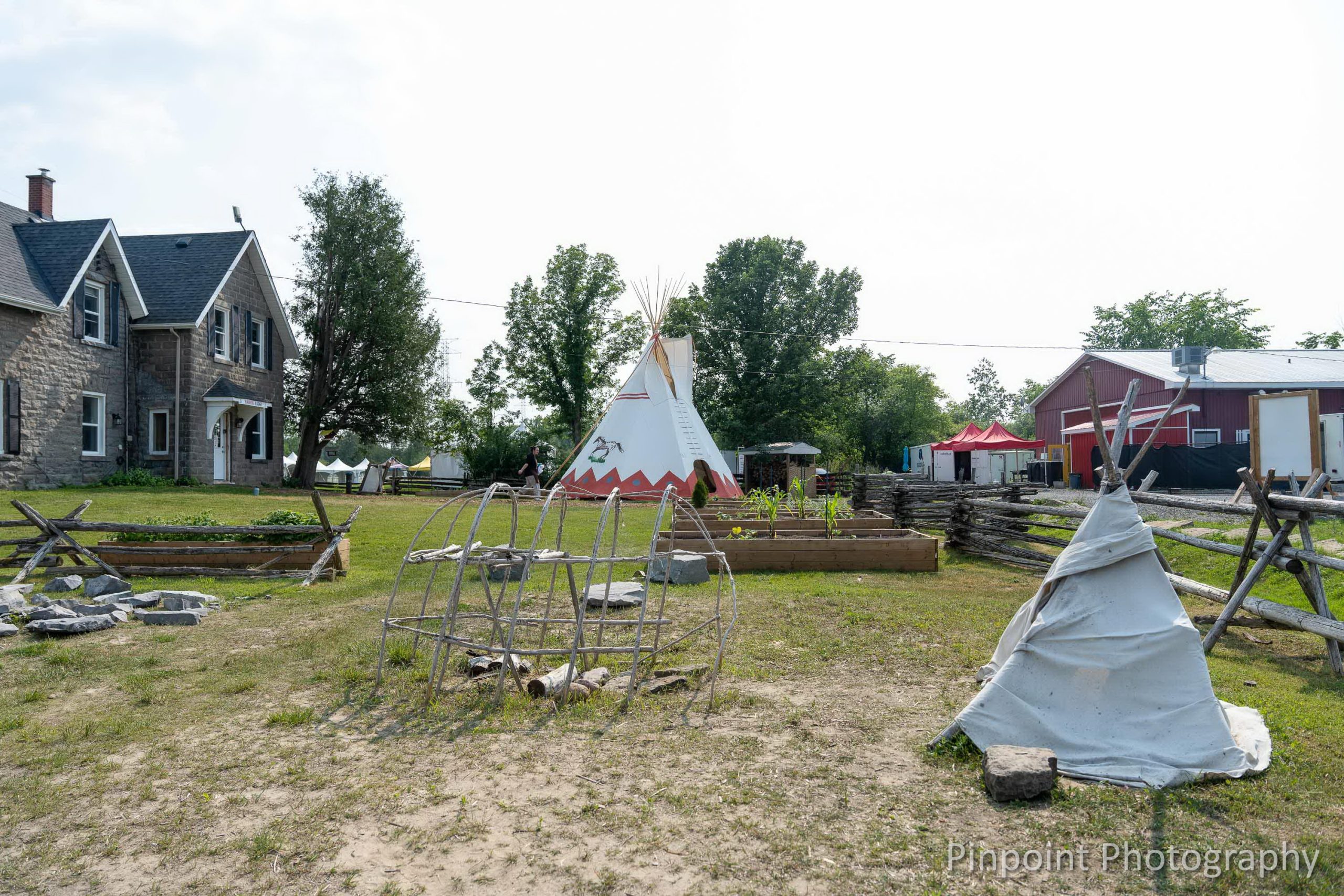 Field with tipis and other wooden structures