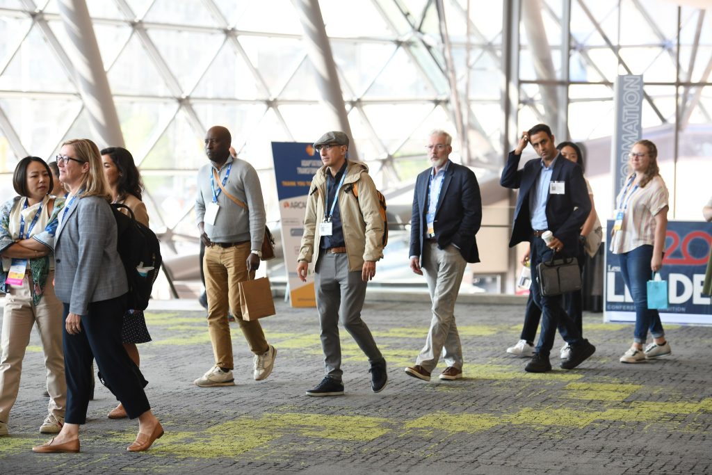 Conference Attendees walking toward escalator